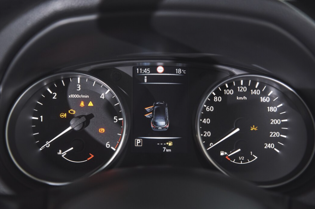 black car dashboard with digital display, tachometer, and speedometer