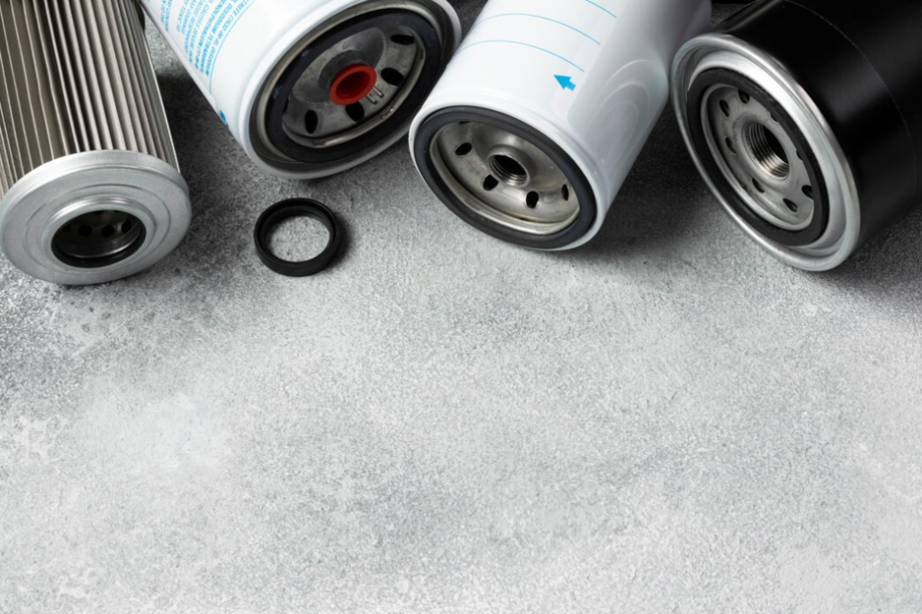 Automotive filters and a rubber ring displayed on a textured gray surface